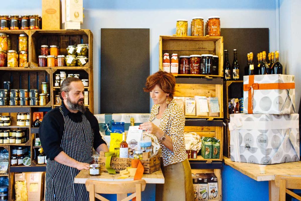 Riccardo Lunardi in the bakery with a customer